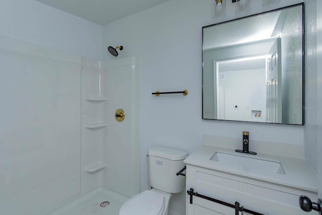 bathroom featuring vanity, toilet, and a shower