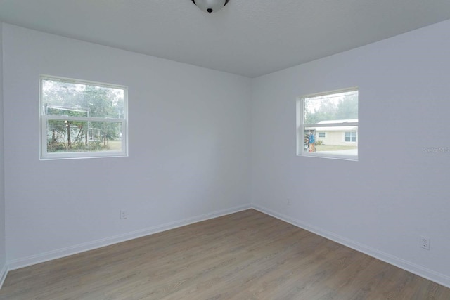 spare room with a healthy amount of sunlight and light wood-type flooring