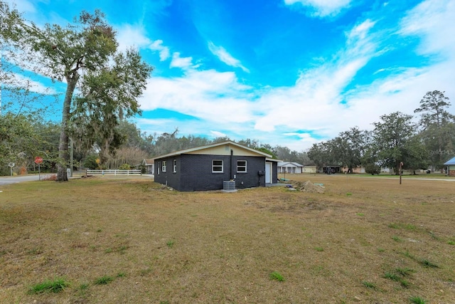 view of side of property with a yard