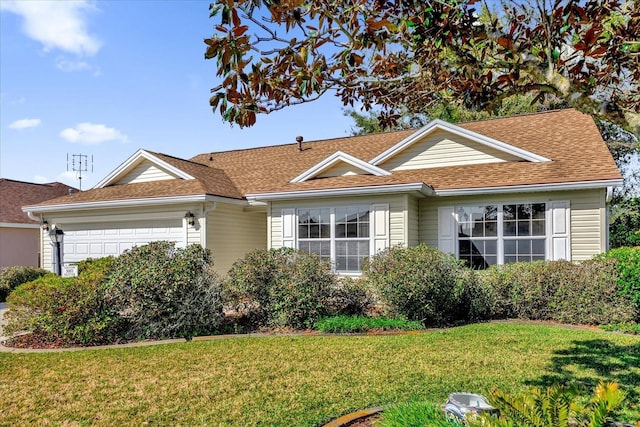 view of front of property featuring a garage and a front yard