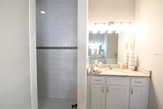 bathroom featuring vanity and tiled shower