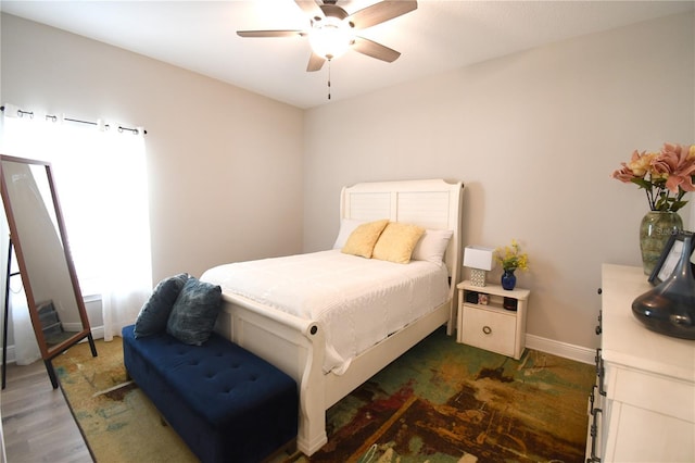 bedroom featuring ceiling fan and dark hardwood / wood-style flooring