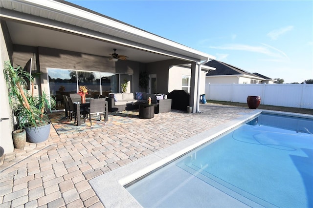 view of swimming pool with ceiling fan, outdoor lounge area, and a patio area