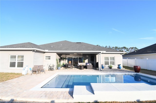 rear view of house with ceiling fan, an outdoor hangout area, a fenced in pool, and a patio