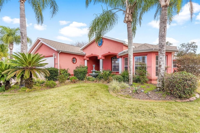 view of front of house with a garage and a front yard