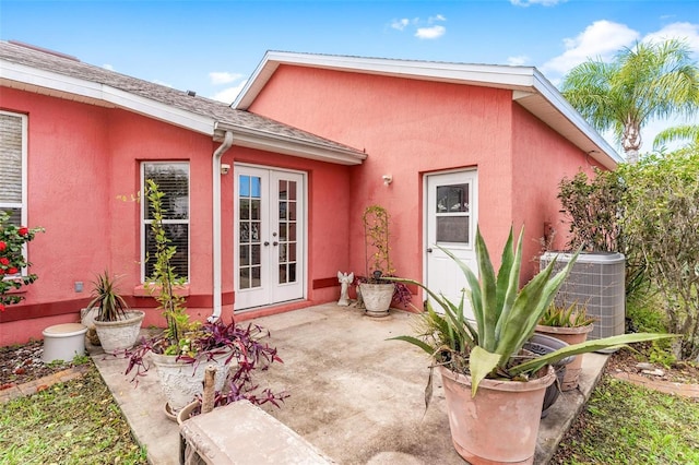 exterior space with french doors, a patio, and central air condition unit