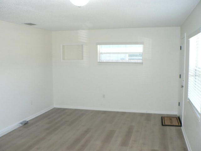 empty room with hardwood / wood-style flooring