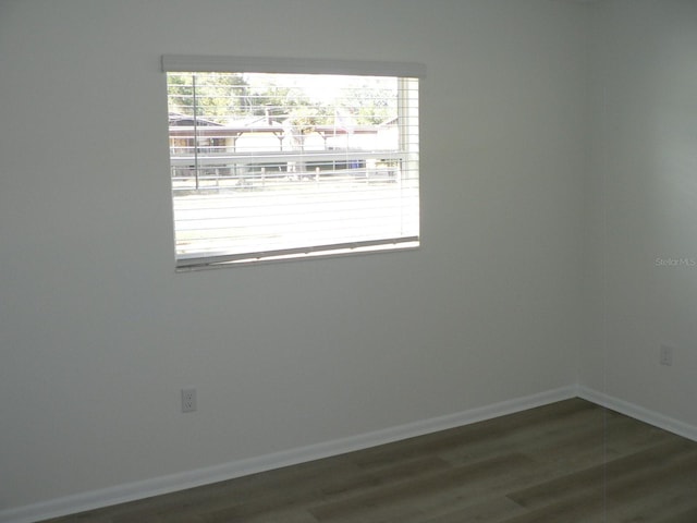 unfurnished room with dark hardwood / wood-style floors