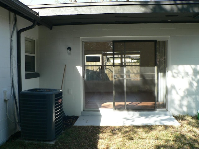 doorway to property with a patio and cooling unit