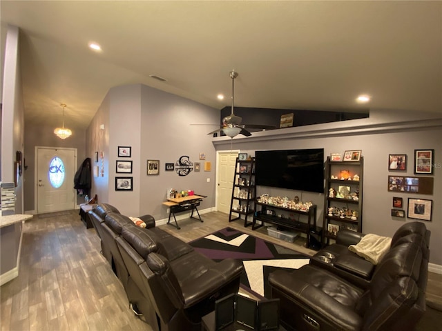 living room featuring vaulted ceiling, wood-type flooring, and ceiling fan