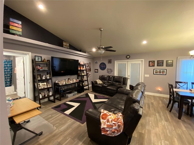 living room with lofted ceiling, french doors, ceiling fan, and light wood-type flooring