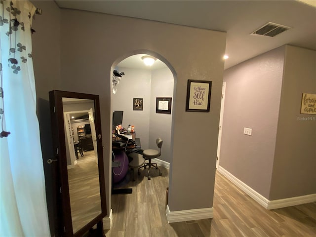 hallway with wood-type flooring