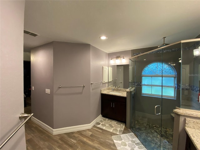 bathroom with vanity, hardwood / wood-style floors, and an enclosed shower