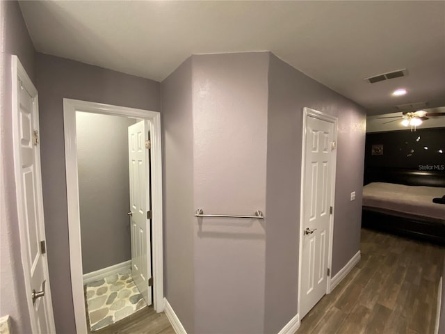 hallway with dark wood-type flooring