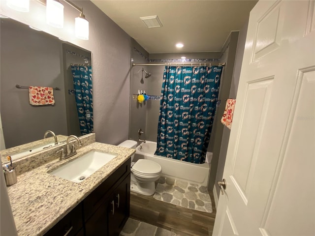 full bathroom featuring shower / bathtub combination with curtain, vanity, toilet, and hardwood / wood-style floors