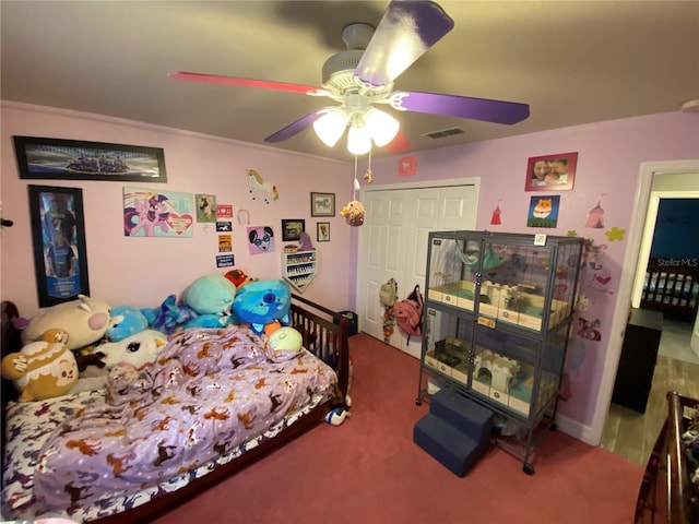 bedroom with carpet, ceiling fan, and a closet