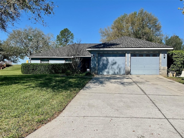 ranch-style home with a garage, a front yard, brick siding, and driveway