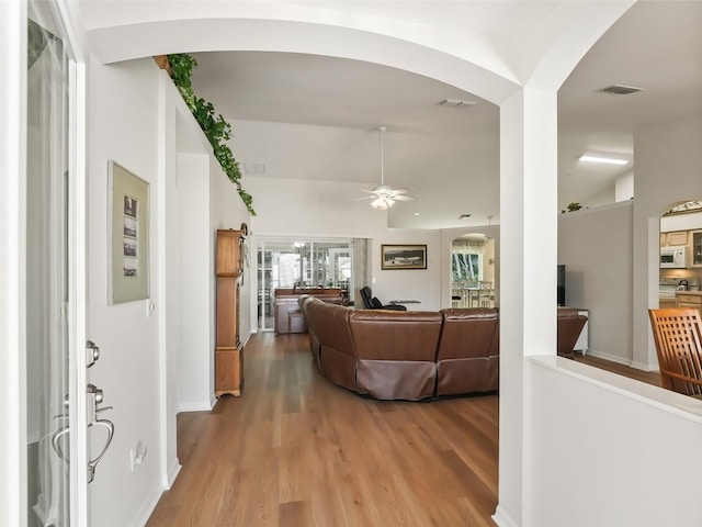 living room featuring ceiling fan and light wood-type flooring