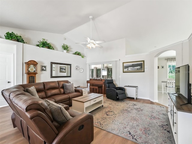 living room featuring high vaulted ceiling, a wealth of natural light, light hardwood / wood-style floors, and ceiling fan