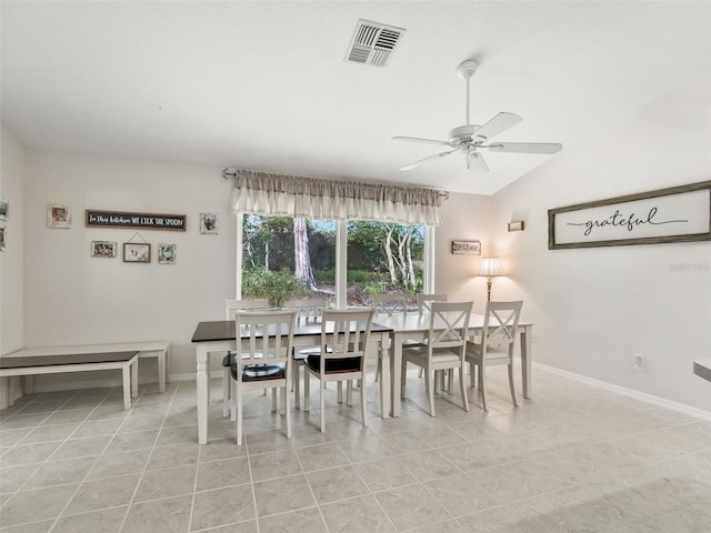 dining area featuring light tile patterned flooring, ceiling fan, and vaulted ceiling