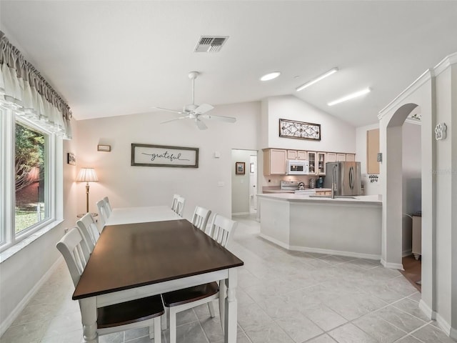 tiled dining space featuring vaulted ceiling and ceiling fan