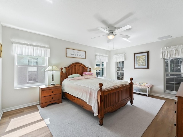 bedroom with ceiling fan and light hardwood / wood-style floors