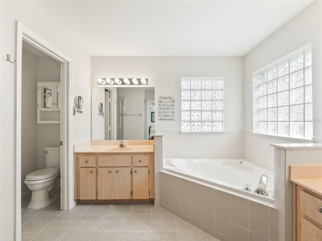 full bathroom with tile patterned flooring, vanity, plus walk in shower, and toilet