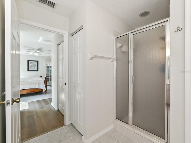 bathroom with tile patterned flooring and a shower with door