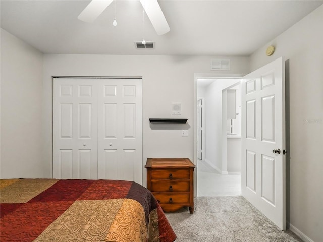 carpeted bedroom with ceiling fan and a closet