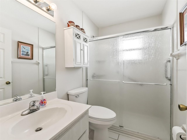 bathroom with an enclosed shower, vanity, and toilet