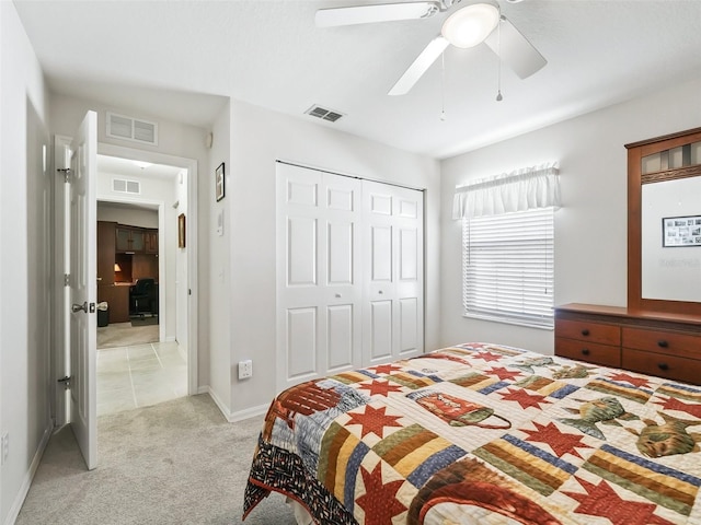 bedroom with light colored carpet, a closet, and ceiling fan