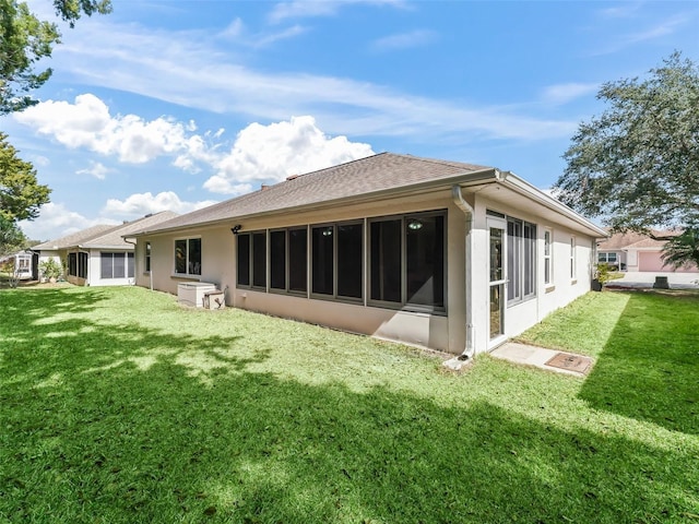 rear view of property with a lawn