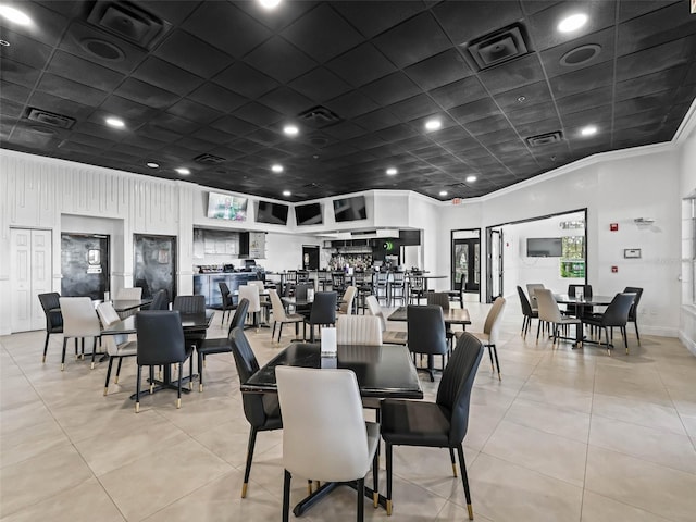 dining area with crown molding, light tile patterned flooring, and visible vents