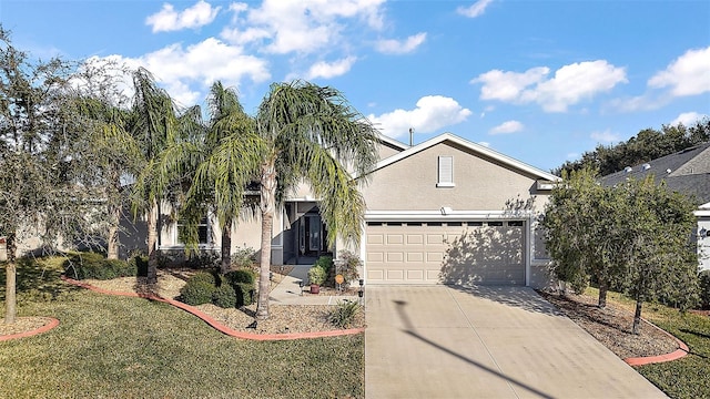 view of front of property with a garage and a front lawn