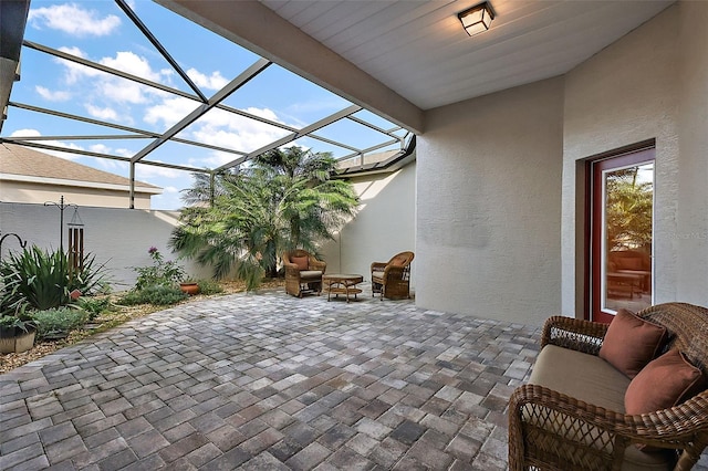 view of patio featuring a lanai