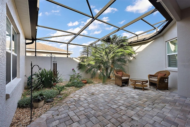 view of patio featuring a lanai