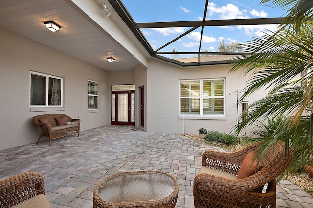 view of patio / terrace featuring glass enclosure