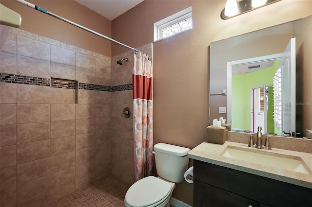 bathroom with toilet, vanity, and walk in shower