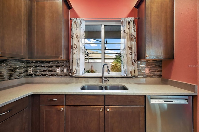 kitchen featuring sink, stainless steel dishwasher, and decorative backsplash