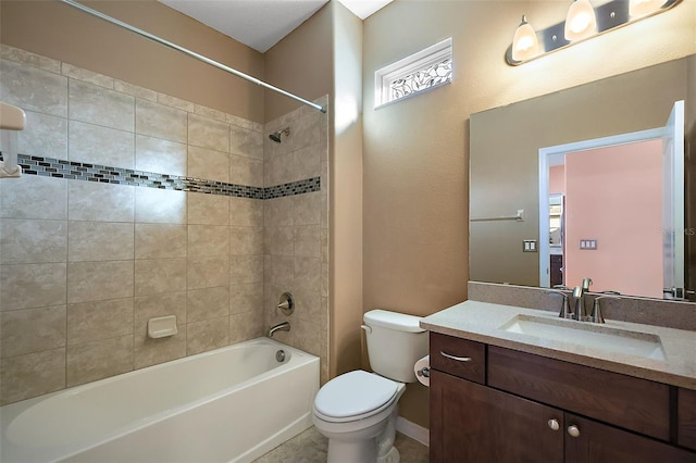 full bathroom featuring vanity, toilet, and tiled shower / bath combo