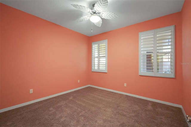 carpeted spare room with ceiling fan