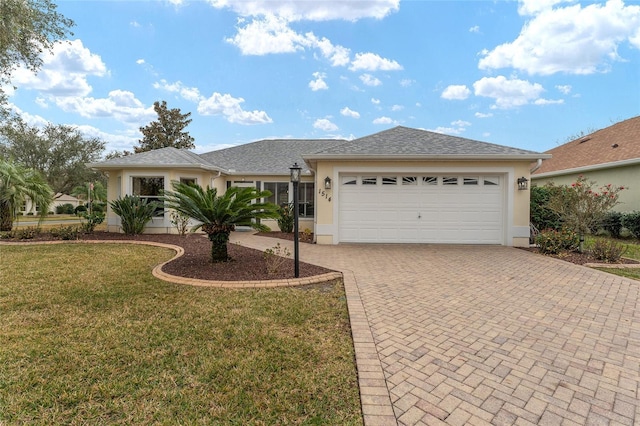 ranch-style home featuring a garage and a front yard