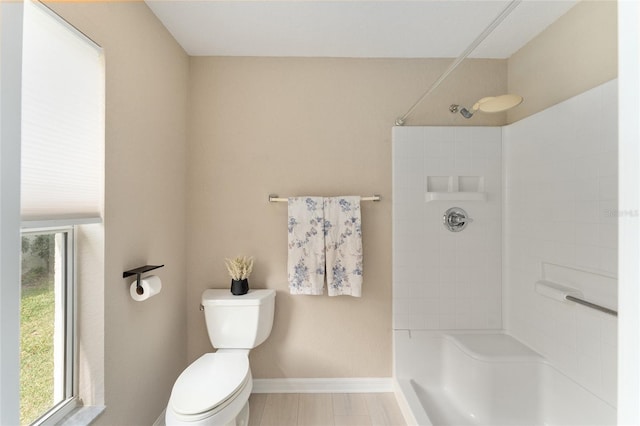 bathroom with walk in shower, a wealth of natural light, and toilet