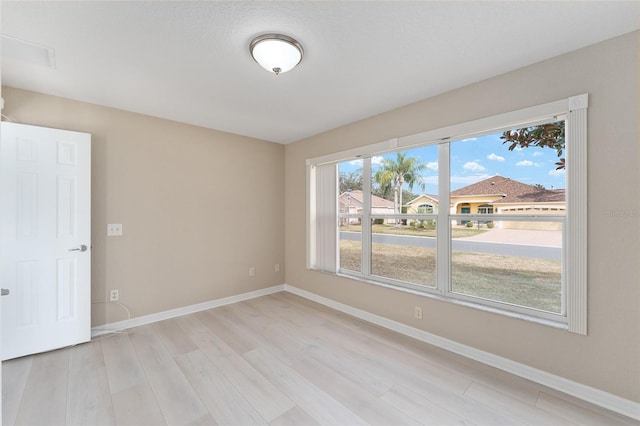 unfurnished room with light hardwood / wood-style flooring