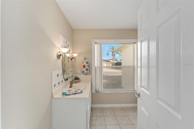 bathroom with tasteful backsplash, vanity, and tile patterned flooring