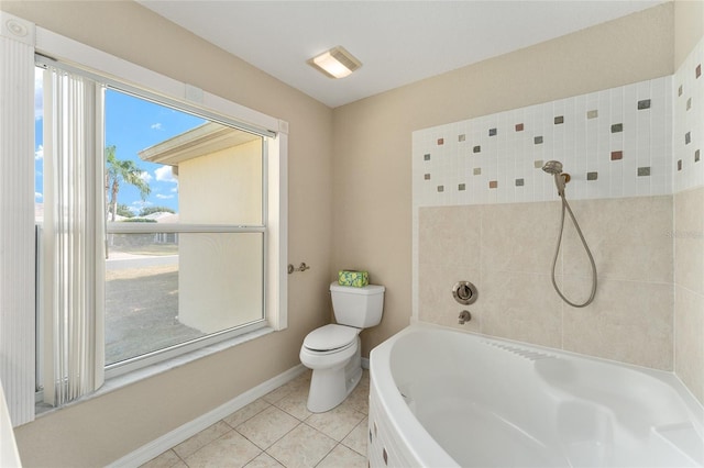 bathroom with tile patterned flooring, a bathtub, and toilet