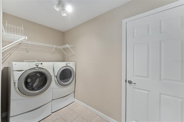 laundry room with light tile patterned floors and independent washer and dryer