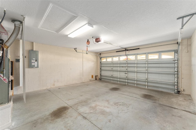 garage with a garage door opener and electric panel