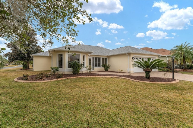 view of front of property featuring a garage and a front lawn