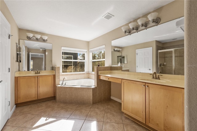 bathroom with vanity, tile patterned floors, and plus walk in shower